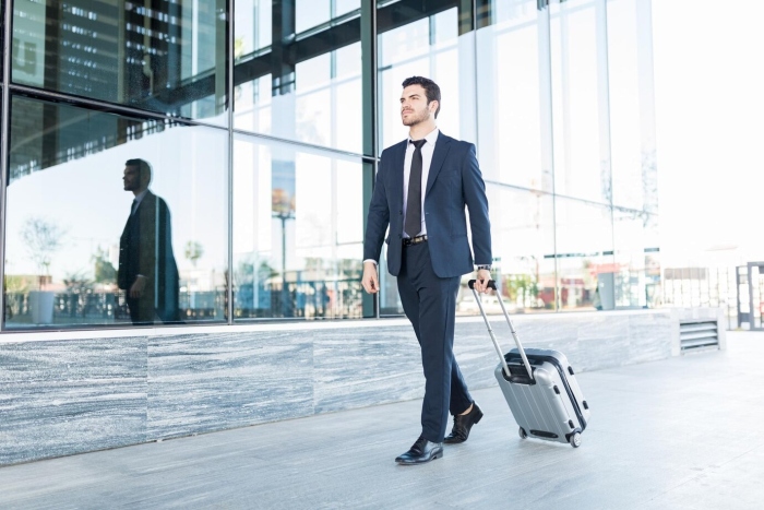 Freepik tonodiaz Businessman walking with luggage - All Events